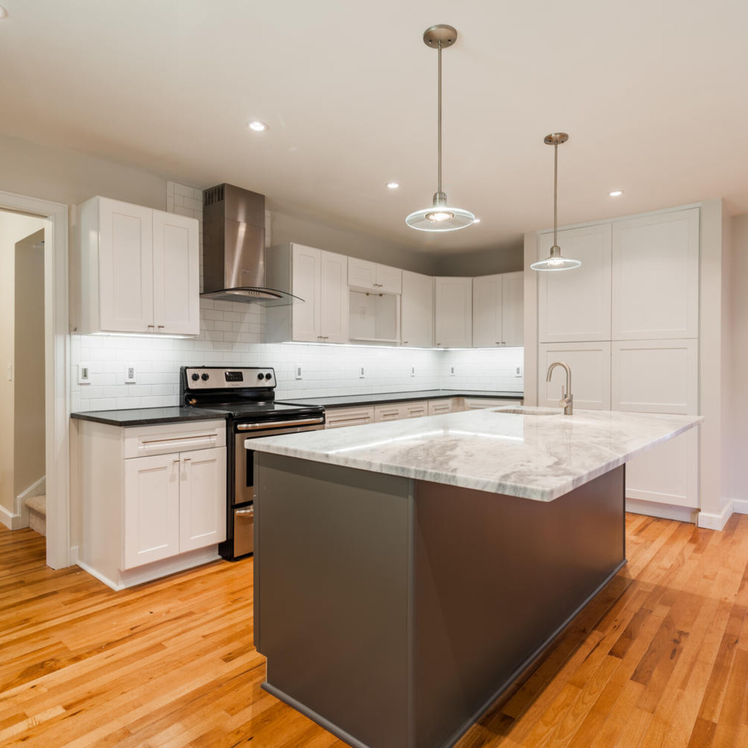 No ugly brackets to bang your knees into under the island overhang. Plenty of countertop receptacles.